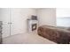 Cozy bedroom featuring a decorative fireplace with TV, neutral carpet, and a comfortable bed at 452 Minim St, Charleston, SC 29414