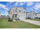 Charming two-story home with a well-manicured lawn, two-car garage, and welcoming front porch at 452 Minim St, Charleston, SC 29414