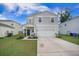 Charming two-story home with a well-manicured lawn, two-car garage, and welcoming front porch at 452 Minim St, Charleston, SC 29414