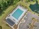 Aerial view of a sparkling community pool, complete with lounge chairs, a clubhouse, and parking at 452 Minim St, Charleston, SC 29414