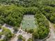 Aerial view showcasing well-maintained tennis courts surrounded by lush green trees and parking at 452 Minim St, Charleston, SC 29414