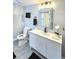 Well-lit bathroom featuring sleek vanity, modern mirror, and gray tile flooring at 4649 N U.S. Highway 52, Saint Stephen, SC 29479