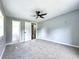 A spacious bedroom with carpeting, fan, and a view into the hallway and closet at 4649 N U.S. Highway 52, Saint Stephen, SC 29479
