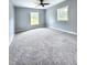 Bright bedroom featuring plush carpeting, two windows and a stylish ceiling fan at 4649 N U.S. Highway 52, Saint Stephen, SC 29479