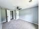 Spacious bedroom with neutral walls, ceiling fan, carpet, and an open door to the hallway and closet at 4649 N U.S. Highway 52, Saint Stephen, SC 29479