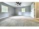 Spacious bedroom featuring soft carpeting, neutral paint, two windows and a modern ceiling fan at 4649 N U.S. Highway 52, Saint Stephen, SC 29479