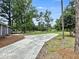 Long concrete driveway leading to a brick home with lush green surroundings at 4649 N U.S. Highway 52, Saint Stephen, SC 29479