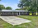 Brick house with a concrete driveway and a well-kept lawn with mature trees at 4649 N U.S. Highway 52, Saint Stephen, SC 29479