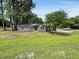 Single-story home featuring brick, metal roof and a well-maintained lawn at 4649 N U.S. Highway 52, Saint Stephen, SC 29479
