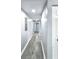 Long hallway showcasing tile flooring, neutral paint, and access to other rooms at 4649 N U.S. Highway 52, Saint Stephen, SC 29479