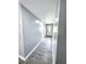Hallway showcasing tile flooring, neutral paint, and smooth transition to carpeted rooms at 4649 N U.S. Highway 52, Saint Stephen, SC 29479