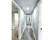 Long hallway with gray walls, gray tile floors, white trim, and recessed lighting leading to other rooms in the house at 4649 N U.S. Highway 52, Saint Stephen, SC 29479