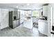 Modern kitchen featuring white cabinets, stainless steel appliances, and gray floors and an island at 4649 N U.S. Highway 52, Saint Stephen, SC 29479