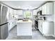 Spacious modern kitchen with white cabinets, quartz countertops, island, and stainless steel appliances at 4649 N U.S. Highway 52, Saint Stephen, SC 29479