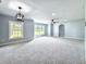 Large living room featuring neutral gray walls, plush carpet, plenty of natural light, and ceiling fans at 4649 N U.S. Highway 52, Saint Stephen, SC 29479