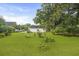 Lush backyard with green lawn and mature trees of residential home at 4735 W Park Pl, North Charleston, SC 29405