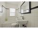 Clean bathroom featuring a tub and sink with a classic black and white design at 4735 W Park Pl, North Charleston, SC 29405