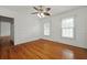 Bright bedroom with wood floors, a ceiling fan, and natural light from two windows at 4735 W Park Pl, North Charleston, SC 29405