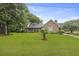 Charming brick home with a well-manicured lawn and mature trees at 4735 W Park Pl, North Charleston, SC 29405