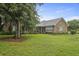 Charming brick home with a lush green lawn and mature trees, offering great curb appeal at 4735 W Park Pl, North Charleston, SC 29405