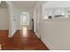 Bright hallway with hardwood floors leading to the kitchen and other rooms at 4735 W Park Pl, North Charleston, SC 29405