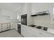 Bright kitchen featuring an electric stovetop, black appliances, and clean white cabinets at 4735 W Park Pl, North Charleston, SC 29405