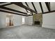 Large living room with vaulted ceilings, beams, and a fireplace adding a cozy ambiance at 4735 W Park Pl, North Charleston, SC 29405