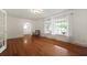 Inviting living room with hardwood floors, large windows, and decorative lighting at 4735 W Park Pl, North Charleston, SC 29405