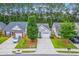 An aerial view of well-maintained homes featuring neat landscaping and private driveways nestled among lush trees at 4831 Carnoustie Ct, Summerville, SC 29485