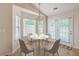 Cozy dining area with a chandelier, seating for four, and natural light, perfect for intimate meals at 4831 Carnoustie Ct, Summerville, SC 29485