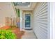 Inviting front entrance features a stylish door with decorative glass, complemented by a well-kept lawn at 4831 Carnoustie Ct, Summerville, SC 29485