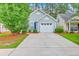 Charming home featuring a driveway and attached garage, complemented by a well-maintained lawn and colorful landscaping at 4831 Carnoustie Ct, Summerville, SC 29485