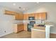 Well lit kitchen featuring light wood cabinets, black appliances, and a breakfast bar at 4831 Carnoustie Ct, Summerville, SC 29485