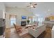 Open-concept living room features a vaulted ceiling, fireplace, hardwood floors, and seamless flow to the kitchen and dining areas at 4831 Carnoustie Ct, Summerville, SC 29485