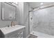 Elegant bathroom with a marble shower, modern vanity, and bronze fixtures at 55 Ashley Ave # 6, Charleston, SC 29401