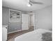 Bedroom featuring neutral paint, closet, wood flooring, and open doorway to bathroom at 55 Ashley Ave # 6, Charleston, SC 29401