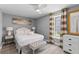 Bright bedroom featuring a comfortable bed, a ceiling fan, and stylish curtains at 55 Ashley Ave # 6, Charleston, SC 29401