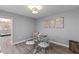 A glass dining table for four and wall art in a dining room with wood floors at 55 Ashley Ave # 6, Charleston, SC 29401