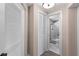 Hallway view to the bathroom with white doors, closet, and tiled floor at 55 Ashley Ave # 6, Charleston, SC 29401