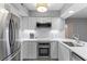 Bright, modern kitchen features white cabinetry, stainless steel appliances and white marble countertops at 55 Ashley Ave # 6, Charleston, SC 29401