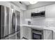 Modern kitchen boasts white cabinetry, stainless steel appliances, and elegant marble backsplash at 55 Ashley Ave # 6, Charleston, SC 29401
