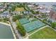 Aerial view of community tennis courts, pool, landscaping and nearby residential area at 55 Ashley Ave # 6, Charleston, SC 29401
