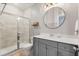 Modern bathroom with white vanity, glass-enclosed shower, and elegant fixtures at 557 Blueway Ave, Summerville, SC 29486