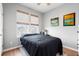 Cozy bedroom with a window view and minimalist décor, showcasing natural light and modern accents at 557 Blueway Ave, Summerville, SC 29486