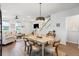 Bright dining area adjacent to living space, featuring stylish table, chandelier, and stairway at 557 Blueway Ave, Summerville, SC 29486