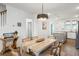 Elegant dining area with a stylish table, wood floors, and direct access to the kitchen at 557 Blueway Ave, Summerville, SC 29486