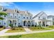 Street view of attractive townhomes with inviting front porches and well-manicured landscaping at 557 Blueway Ave, Summerville, SC 29486