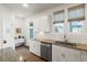 Modern kitchen featuring white cabinets, granite countertops, stainless steel appliances, and tile backsplash at 557 Blueway Ave, Summerville, SC 29486