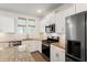 Well-equipped kitchen with white cabinets, granite counters, stainless steel appliances, and subway tile backsplash at 557 Blueway Ave, Summerville, SC 29486