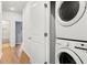Convenient laundry area with stacked washer and dryer, adjacent to a hallway and nearby bathroom at 557 Blueway Ave, Summerville, SC 29486